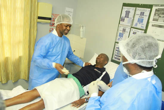 KwaZulu-Natal Health MEC Dr Sibongiseni Dhlomo with Melusi Yende the one millionth man to get circumcised.