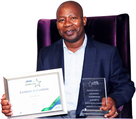 Phumlani Ngwenya holding his Ithala Business Achiever Award certificate.