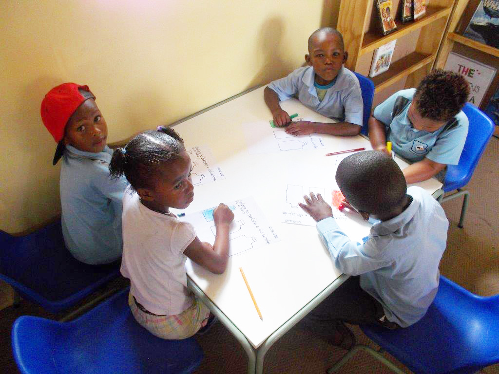 Learners at Paballo ECD learning to write.