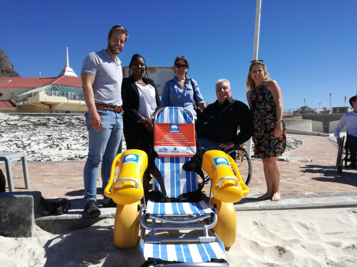 Jakkie Pieters from The National Council for Persons with Physical Disabilities in South Africa accepts their amphibious wheelchair on behalf of the Kouga Municipality.