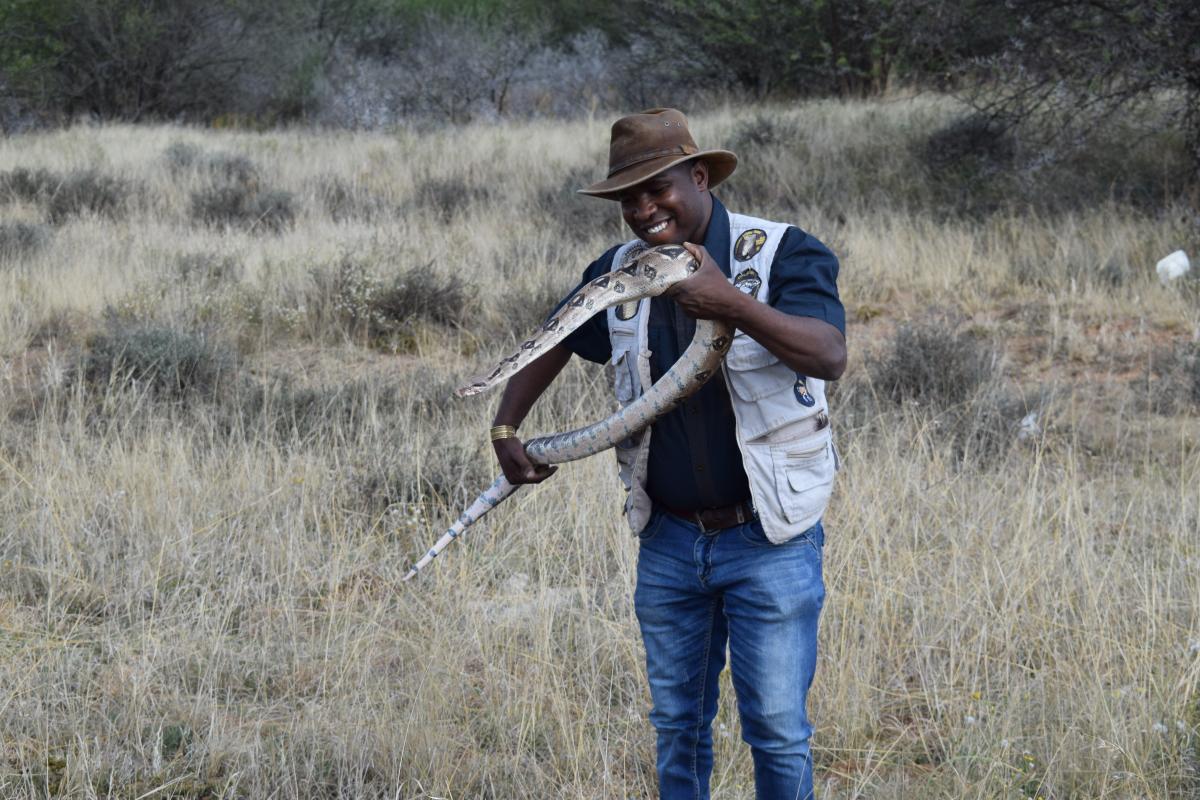 Herpetologist Harry Baloyi with his pet Cecilia.