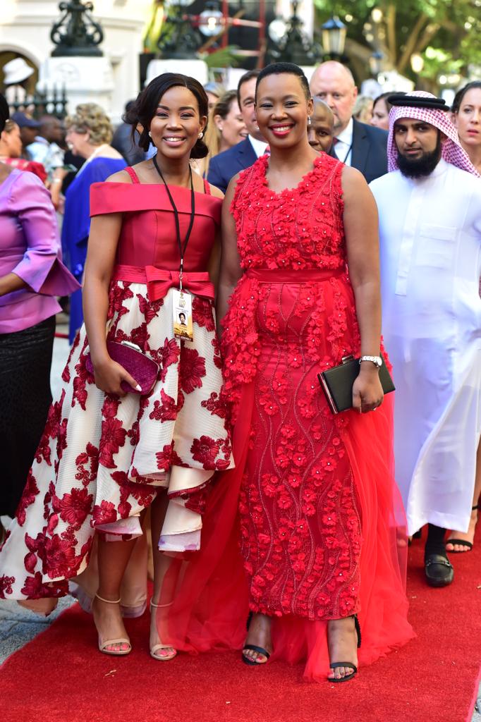 Minister of Communications Stella Ndabeni- Abrahams(right) in a red dress.