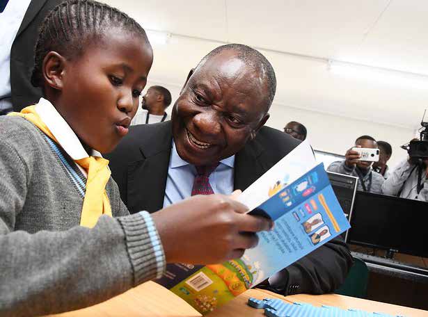 President Cyril Ramaphosa with a Grade 1 learner from the newly opened Enhlanhleni Primary School in Dannhauser near Newcastle in KwaZulu-Natal.