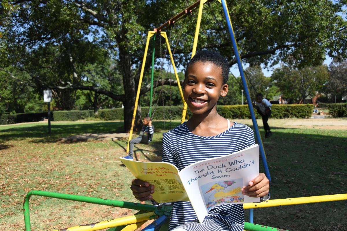 Young writer Adaeze Ogechi Ugwu with her book titled The Duck Who Thought It Couldn't Swim.