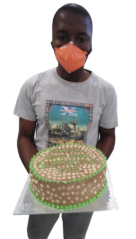 Davy Tsopo with one of the cakes that he recently baked.