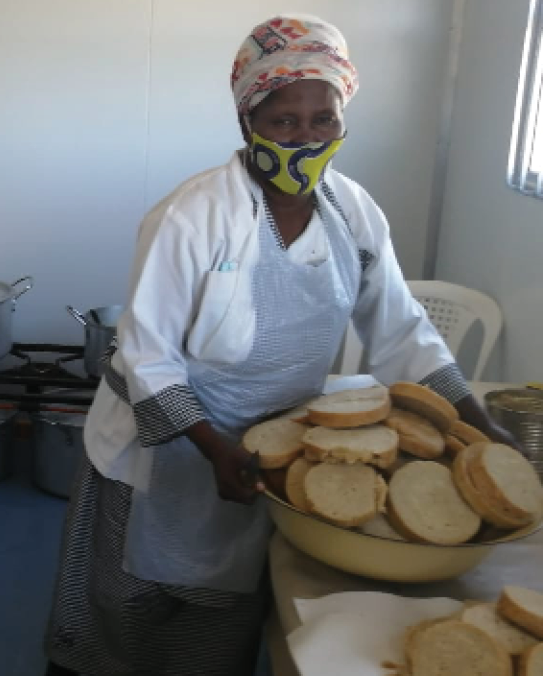 Members of the Phumalanga Nutrition and Development non-governmental organisation serve meals to the community of Tholeni village in Butterworth, Eastern Cape.