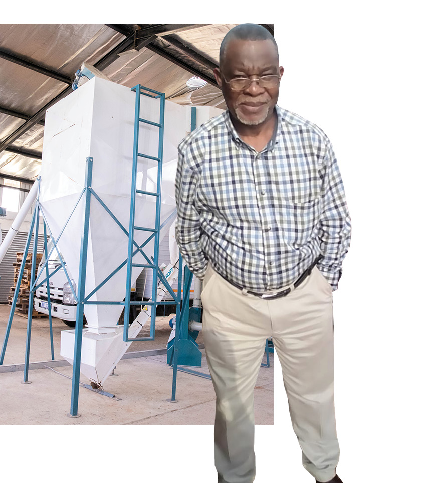 Treasurer of Maphophoma Milling Sipho Nyembe alongside the milling silos that were built by the ADA.