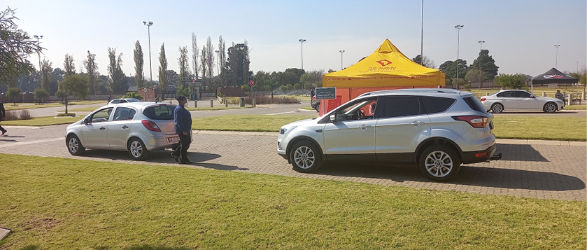 Ekurhuleni residents receive their COVID-19 vaccines in their cars at a drive-through vaccination site.