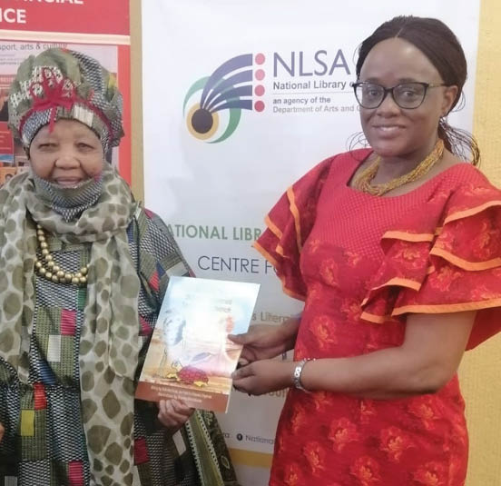Ouma Katrina shows off her book with Executive Director of the National Library of South Africa Nokuthula Musa. Image: National Library of South Africa
