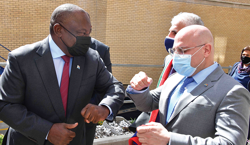 President  Cyril Ramaphosa  with Group Senior  Executive for  Strategic Trade at  Aspen Pharmacare,  Dr Stavros Nicolaou.