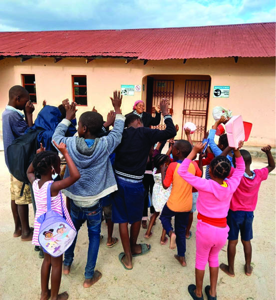 Linah Sekgoka playing with the children from the Lafata Drop-in Centre, which gives hope and provides safety to many young children in her neighbourhood.