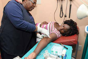 Sister Rebecca Mokoma of Laudium Community Health Centre inserts the sub-dermal contraceptive device into the arm of Dipuo Moyeni. The device is one of the many contraceptive methods government is urging women to use to prevent unplanned pregnancies.