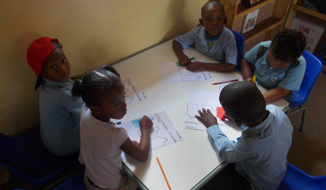 Learners at Paballo ECD learning to write. 