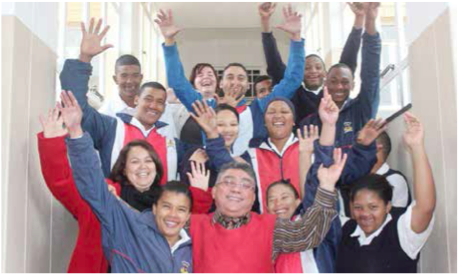 School principal Andries Botha surrounded by some of his jubilant learners. Learners with special education needs feel welcome at the school.