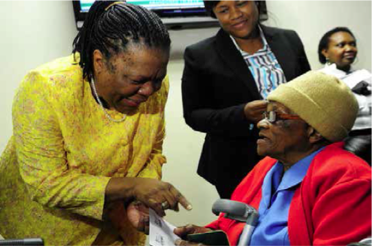 Photo caption: Home Affairs Minister Naledi Pandor hand over a Smart ID card to Johana Ramanyoga at Byron Place in Pretoria.