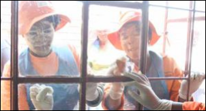 Bekkersdal community members clean up the local clinic after it was damaged during service delivery protests.