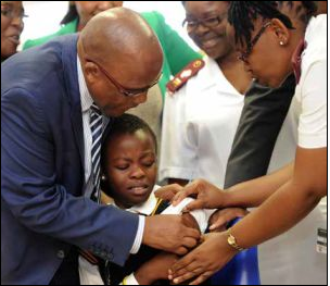 Health Minister Aaron Motsoaledi administers the Human Papilloma Virus vaccine to a learner at the Gonyane Primary School in Bloemfontein.