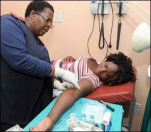 Sister Rebecca Mokoma of the Laudium Community Health Centre inserts the new sub-dermal contraceptive device into the arm of Dipuo Moyeni. The device is free at government clinics and is effective for three years.