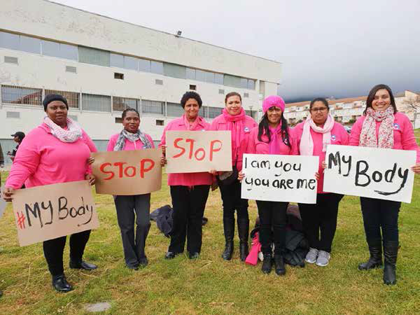 Staff from Sisters Incorporated who are part of the Womens Shelter Movement participate in a march against women abuse